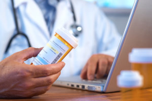 doctor holding prescription bottle