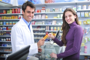 pharmacist handling a medicine tablet to a pharmacy customer